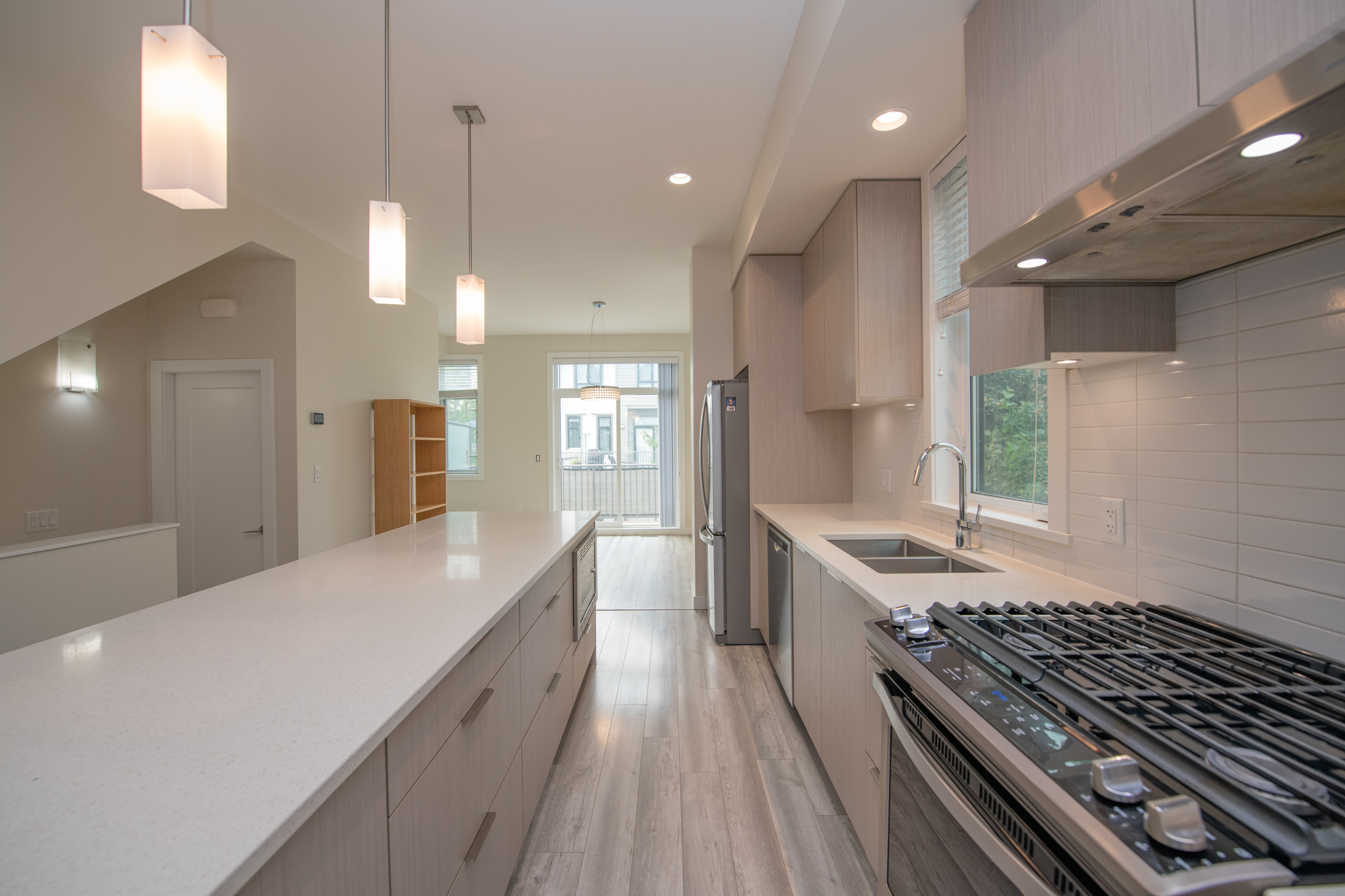 Kitchen with large island, gas range and window over the sink