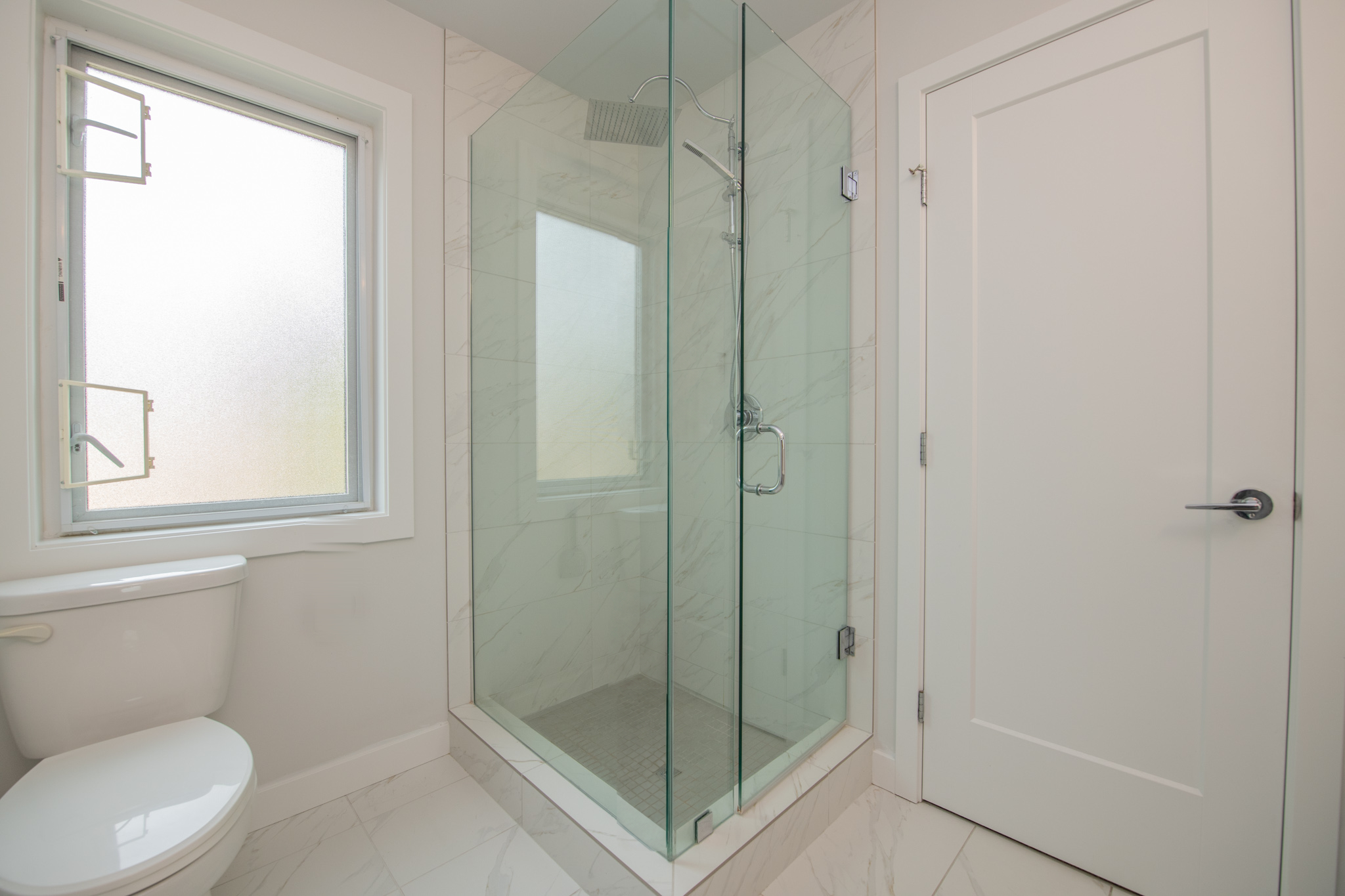 Bathroom with a glass-enclosed tiled shower